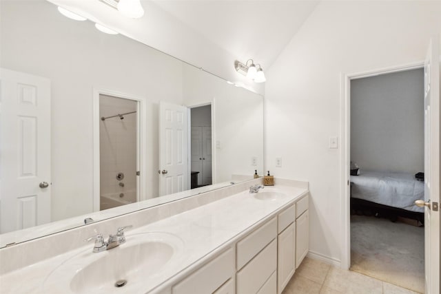 bathroom featuring vanity, vaulted ceiling, tile patterned floors, and shower / bath combination