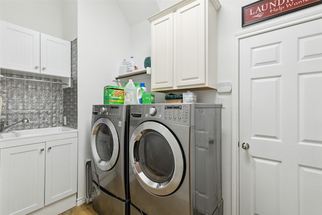 laundry area featuring cabinets, washing machine and dryer, and sink