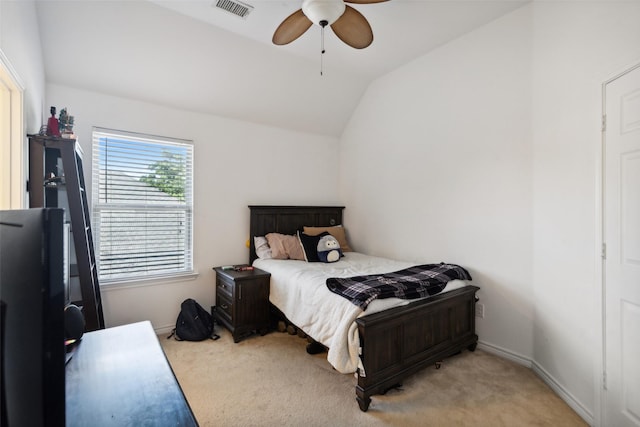 bedroom with vaulted ceiling, light colored carpet, and ceiling fan