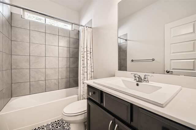 full bathroom with tile patterned floors, shower / tub combo with curtain, vanity, and toilet