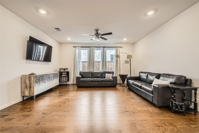 living room with hardwood / wood-style floors and ceiling fan