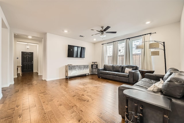 living room featuring ceiling fan and wood-type flooring