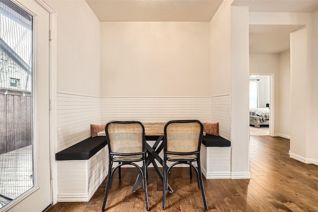 dining space with breakfast area and dark hardwood / wood-style floors