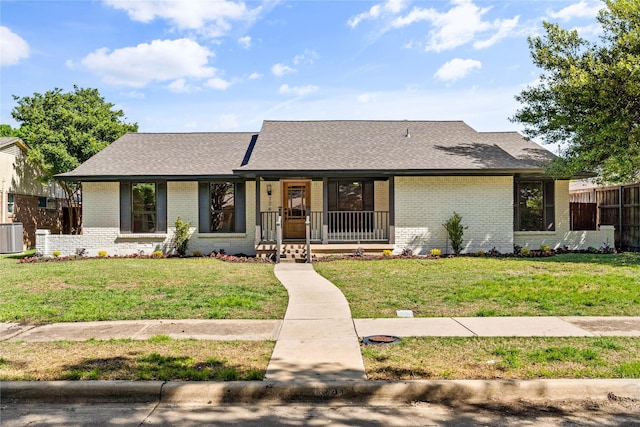 single story home featuring cooling unit and a front lawn