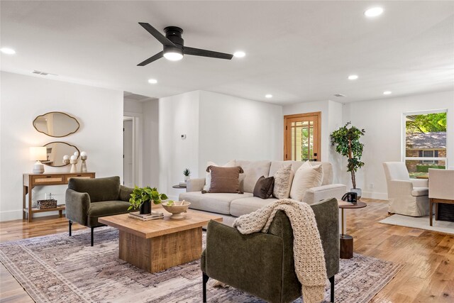 living room featuring ceiling fan and light wood-type flooring