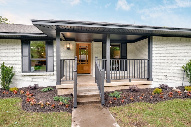 view of exterior entry with covered porch