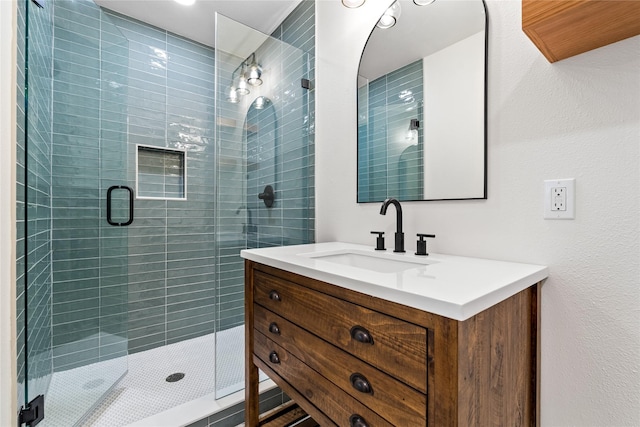 bathroom featuring vanity and a shower with door