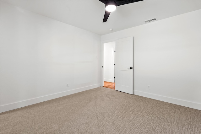 empty room with light colored carpet and ceiling fan