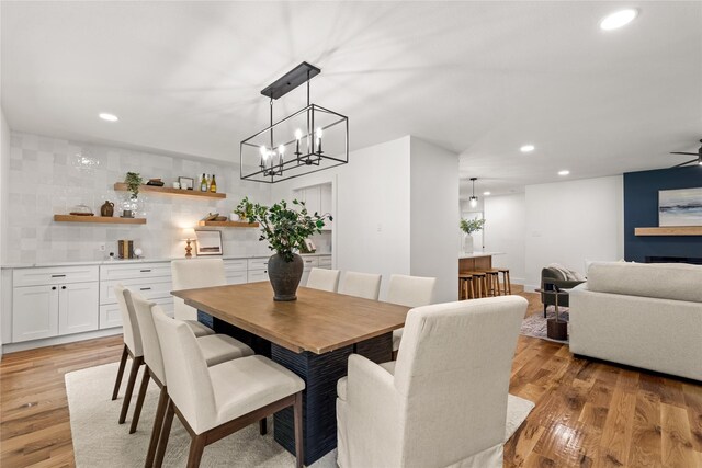 dining area with ceiling fan and light wood-type flooring