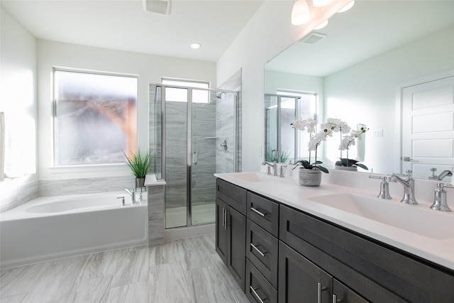 bathroom featuring separate shower and tub, plenty of natural light, and vanity