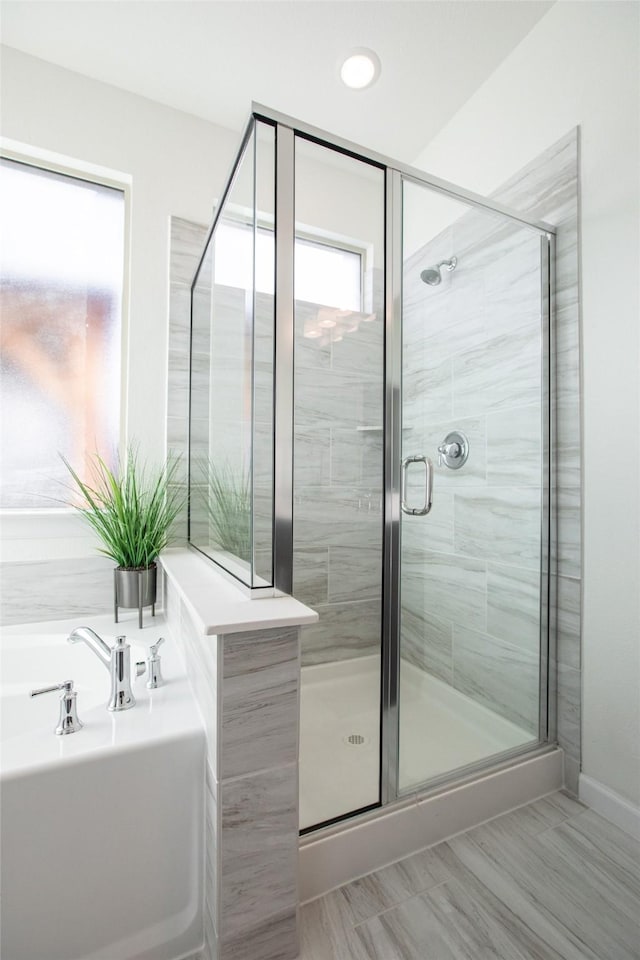 bathroom featuring independent shower and bath