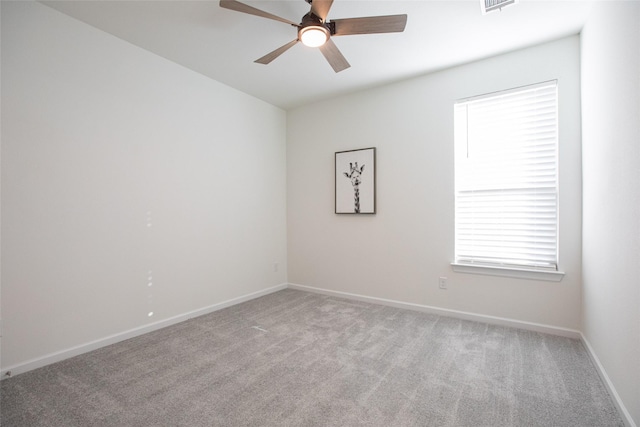 spare room featuring ceiling fan and light colored carpet