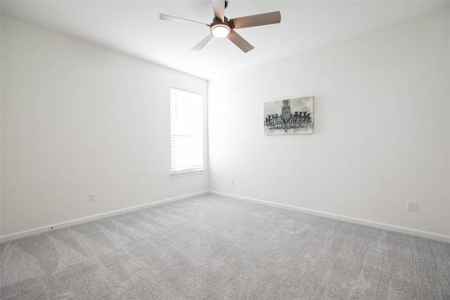 spare room featuring ceiling fan and carpet floors