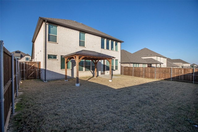 rear view of house featuring a gazebo