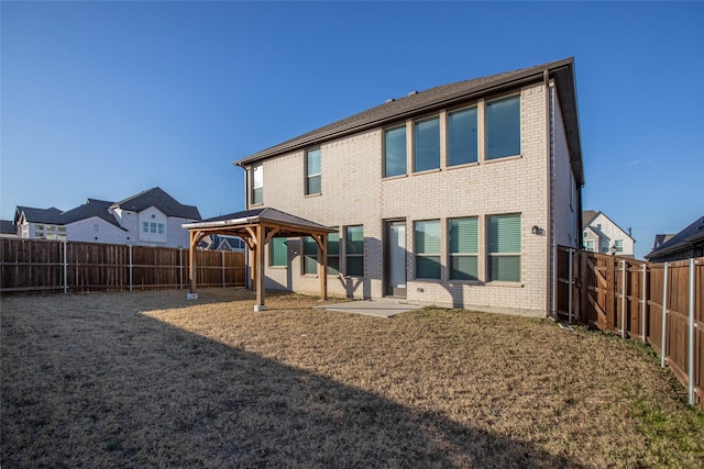 back of property featuring a gazebo