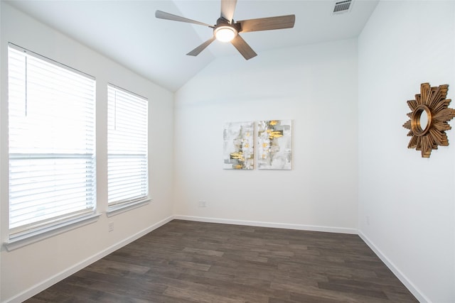 spare room with dark hardwood / wood-style floors, ceiling fan, and lofted ceiling