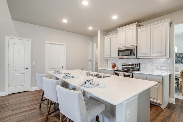 kitchen featuring white cabinetry, a kitchen island with sink, and stainless steel appliances