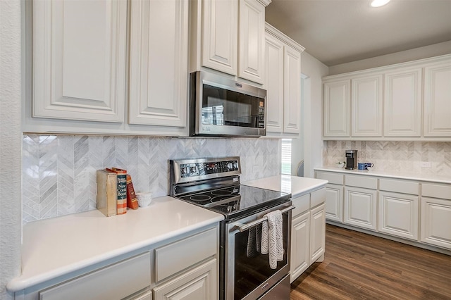 kitchen featuring tasteful backsplash, dark wood-type flooring, white cabinets, and appliances with stainless steel finishes