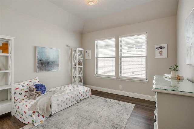 bedroom with lofted ceiling and dark wood-type flooring