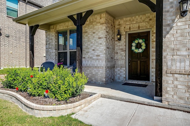 view of exterior entry featuring covered porch