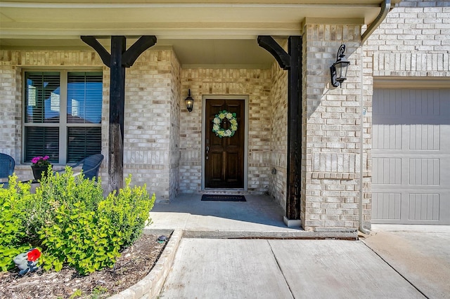 view of exterior entry with a porch