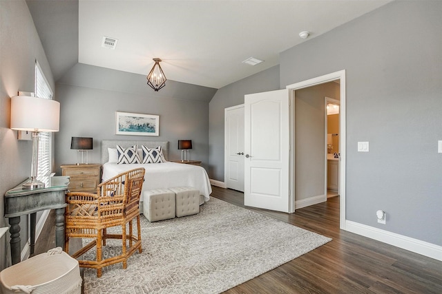 bedroom featuring vaulted ceiling, dark hardwood / wood-style floors, and an inviting chandelier