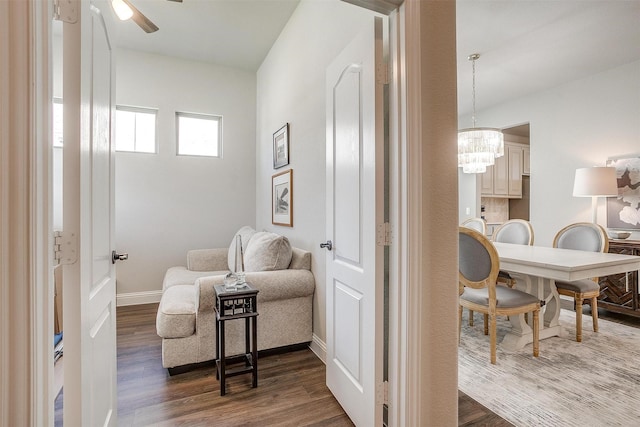 living area with wood-type flooring and ceiling fan