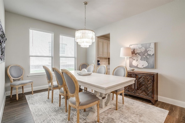 dining area featuring dark hardwood / wood-style floors and a notable chandelier