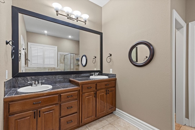 bathroom featuring tile patterned flooring, vanity, and an enclosed shower