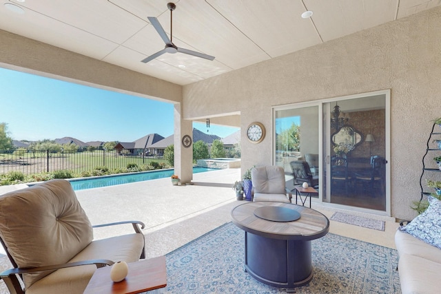 view of patio / terrace with a fenced in pool and ceiling fan