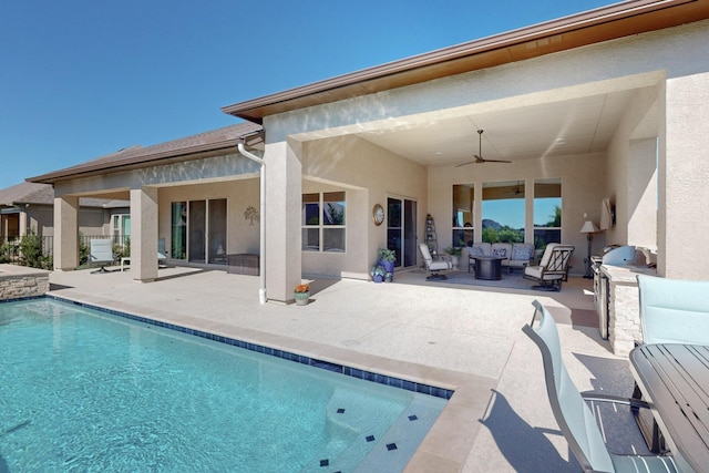 rear view of property featuring outdoor lounge area, ceiling fan, and a patio