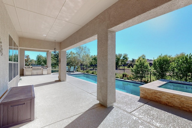 view of swimming pool with an in ground hot tub, a patio, and area for grilling