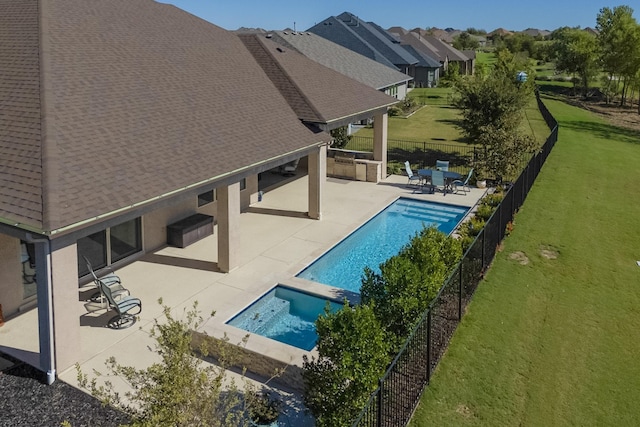 view of swimming pool with a patio area, a yard, and an in ground hot tub