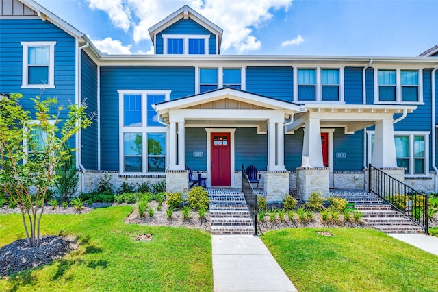 view of front of property with a porch and a front yard