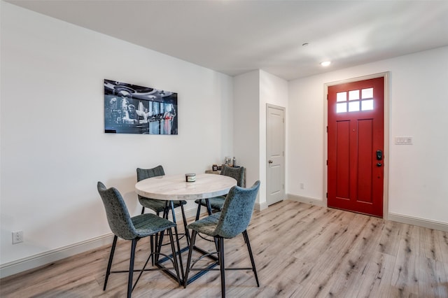 dining space with light hardwood / wood-style flooring