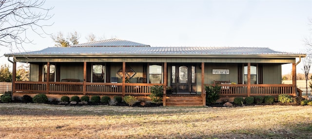 view of front of home featuring a porch and metal roof