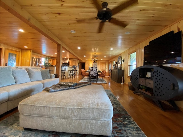 living area with recessed lighting, wood ceiling, ceiling fan, wood walls, and wood finished floors