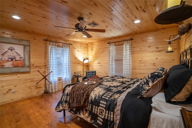 bedroom with recessed lighting, wood walls, wood finished floors, visible vents, and wood ceiling