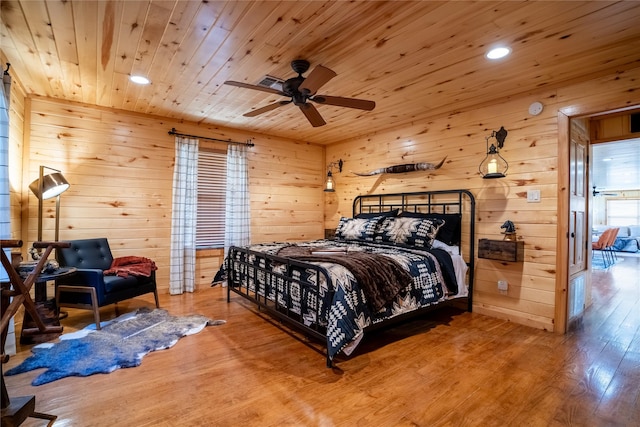 bedroom featuring wood walls, wood ceiling, wood finished floors, and recessed lighting