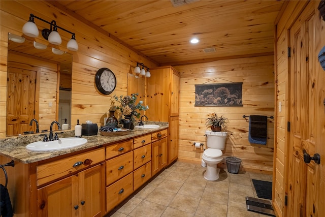 bathroom featuring toilet, wooden ceiling, a sink, and tile patterned floors