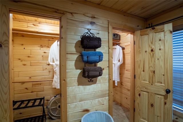 interior space with wood ceiling and wooden walls