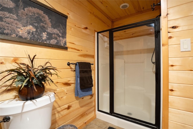 bathroom with toilet, wooden walls, a shower stall, wooden ceiling, and tile patterned floors