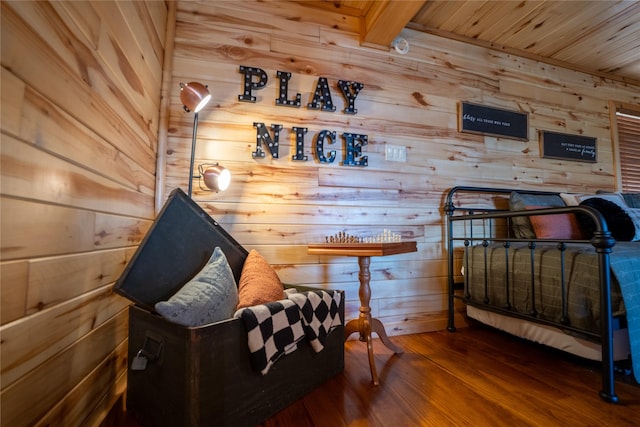 sitting room with wood walls, wood finished floors, and wood ceiling