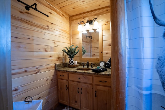 bathroom with wooden ceiling, wooden walls, and vanity