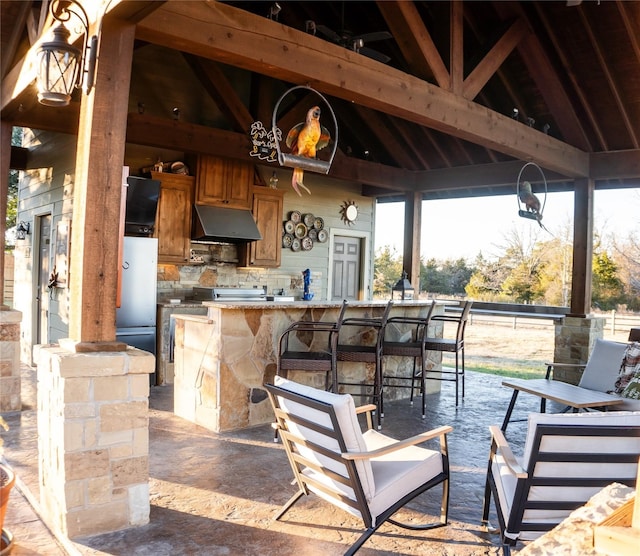 view of patio with a gazebo, area for grilling, and outdoor wet bar