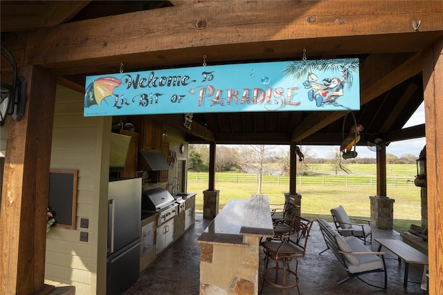 view of patio with a rural view, fence, grilling area, and area for grilling