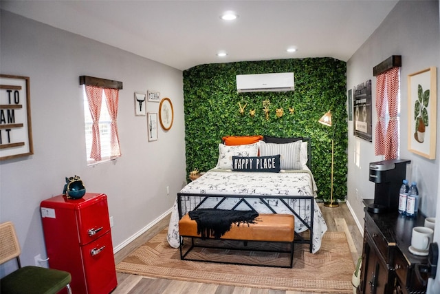 bedroom with baseboards, an AC wall unit, wood finished floors, and recessed lighting