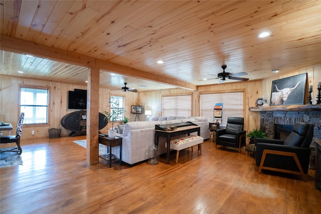 living room with a fireplace, light wood finished floors, recessed lighting, a ceiling fan, and wood ceiling