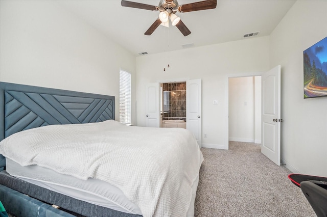 carpeted bedroom featuring ceiling fan and ensuite bathroom