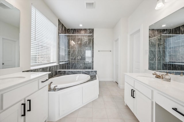 bathroom featuring vanity, plus walk in shower, and tile patterned flooring